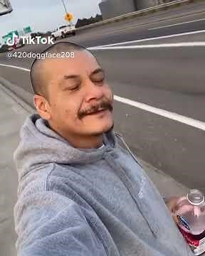 TikTok Guy riding on skateboard on highway drinking cranberry juice