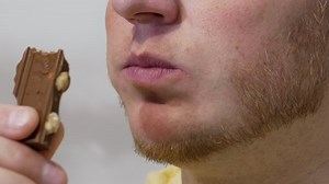 Young Man Eats Appetizing Chocolate Nut Stock Footage Video (100% Royalty-free) 1097968507 | Shutterstock