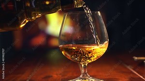 Cognac. Pouring Brandy from a Bottle to a Glass Stock Video