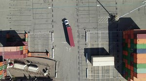 Overhead of transport truck in intermodal container yard, 4K aerial