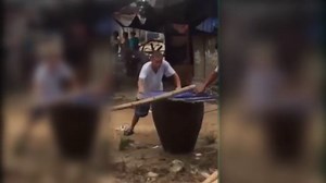 Sick moment Chinese villagers boil howling dog alive for party