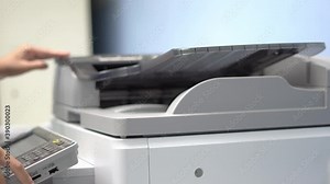 Female workers are working on documents by copying documents with a multifunction copier machine.