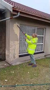 Stripping paint from concrete wall with high presurre water.