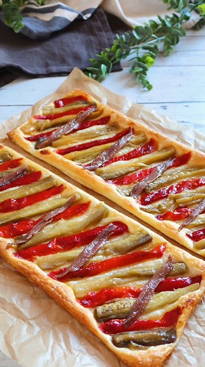 Prepara una coca rápida con hojaldre. Receta de COCA DE RECAPTE CON HOJALDRE: INGREDIENTES para 4 personas: 1 lámina de hojaldre rectangular Pimiento y berenjena asados Anchoas Aceite de oliva Sal ELABORACIÓN: 1. Corta por la mitad la lámina de hojaldre y coloca encima de cada mitad unas tiras de pimiento y berenjena asados. Riega con un chorrito de aceite y sazona al gusto. 2. Hornea a 200º C - 392º F durante 20 minutos o hasta que el hojaldre esté dorado. 3. Cuando salga del horno reparte por 