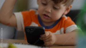 Upset little boy angry with technology child hitting phone screen being frustrated