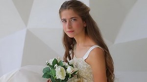 Young model girl 12 y.o. dressed in white clothes with flowers, photo shooting process. Teens health concept. Celebrating of uniqueness and positive self image. Natural beauty real young girl portrait