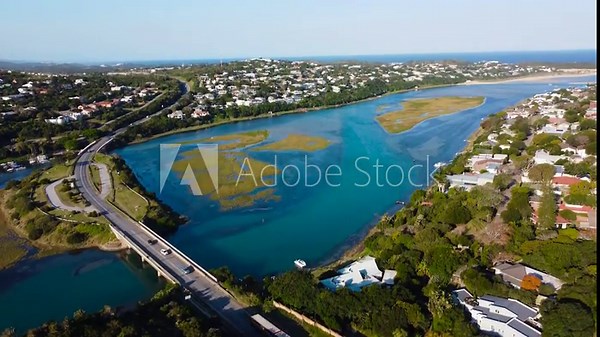 Kenton on Sea small coastal town, camera up over the tow,n rivermout,h and sea 4K Aerial video