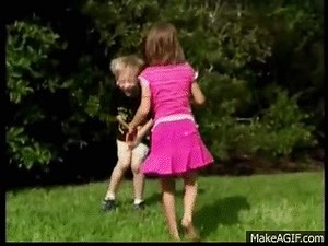 Girl in skirt kicks boy in the balls on Make a GIF