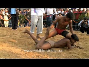 Indian kids compete at a mud wrestling in Delhi