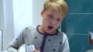 Funny little singer singing cheerfully in bathroom. Real time 4k video footage.