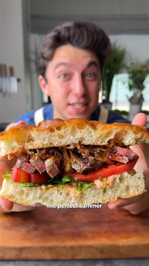 Eitan Bernath on Instagram: "What happens when you take sun-dried tomato aioli, balsamic-dressed arugula, salted heirloom tomatoes, seared strip steak, and caramelized onions, and load them all in between toasted focaccia? The ultimate summer steak sandwich is what happens! This recipe speaks for itself, so need I say more? Ingredients: For the Caramelized Onions: 3 tablespoons extra-virgin olive oil 2 Vidalia onions, thinly sliced Kosher salt, to taste For the Sun-dried Tomato Aioli: 1/2 cup ma