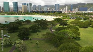 Cinematic 4K aerial drone shot of high-rise hotels, boat harbor, marina, Ala Moana Center on the shore of Ala Moana, near Honolulu on Oahu island in Hawaii known for its popular surfing and beaches