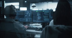 Young Team of Specialists Working on Desktop Computers and Having a Conversation at a Workplace. Female and Male Software Developers Discussing a Solution for Their Artificial Intelligence Project