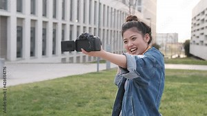 Asian woman vlogging and using camera, social media influencer content creator lifestyle