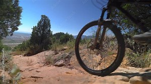 Red Rocks Morrison Golden Colorado adult male mountain biking biker downhill boulders static close up tires Dinosaur Ridge Dakota Ridge Trail sport fitness Denver foothills front range sunny day
