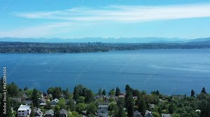 Drone flying over Seattle with views of Bellevue, the Cascade Mountains and Lake Washington.