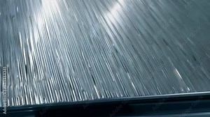 Observing liquid metal cooling process on a flat surface in a workshop setting during mid-day