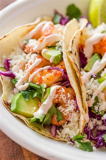 Bet you can’t eat just one of these garlic‑lime shrimp tacos! 🤤🌮 RECIPE: https://natashaskitchen.com/shrimp-tacos/ | NatashasKitchen.com