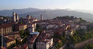 Drone aerial view of Bergamo - Old city (Citta' Alta). One of the beautiful city in Italy. Landscape on the city center and its historical buildings during a wonderful blu day