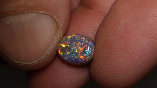 6.5K views · 348 reactions | When pinfire and floral patterns collide, color erupts—and this dark opal is proof. Fiery golds and oranges mix with cool blues and greens, casting a full-spectrum glow across the gem’s face. 2.39ct dark opal 10×7.8×4.5mm https://blackopaldirect.com/product/opal/dark-opal/2-39-ct-semi-black-opal-10x7-8x4-5mm/ | Black Opal Direct | Facebook