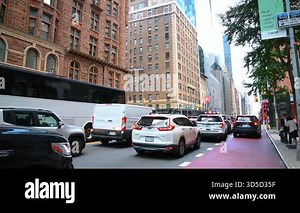 New York, USA, 1 August 2025: Manhattan street traffic and architecture. Traffic jam on a Manhattan street surrounded by red-brick