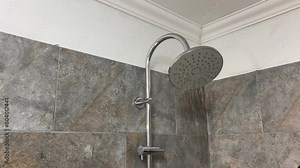 Close up of Water flowing from shower in bathroom interior. running water of shower faucet.