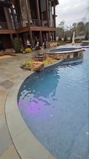 Large freeform pool with raised spa, grotto waterfall and bluestone coping and d | Master Of Thepools