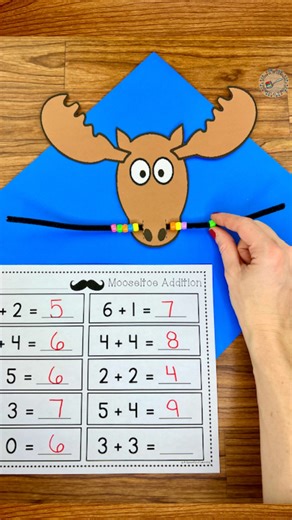 Jaime l Teacher Resources on Instagram: "Let’s have some fun practicing addition! Have you read the adorable story, ‘Mooseltoe’? It is a class favorite during this time of year. A fun and interactive follow-up activity to go along with this adorable story is to practice addition equations on Moose’s moustache… with beads!! Comment MOOSE to get this activity and more sent straight to your DMs."