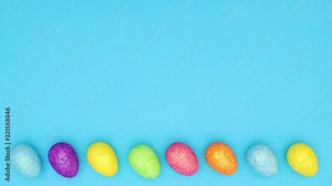 Easter eggs moving in circle on bottom of blue background - Looping stop motion