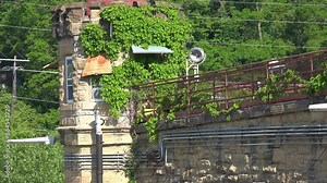 IOWA - 6.28.2024 - Medium close-up of an ivy-covered tower of the Iowa State Penitentiary.