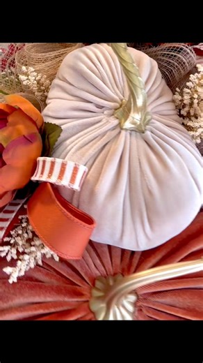 Welcome Autumn in style with this stunning Fall velvet pumpkin floral swag. Designed with 2 velvet pumpkins in rich orange and cream, this elegant arrangement is filled with lush greenery, autumn florals, and farmhouse-inspired ribbons. The perfect blend of rustic and refined, this sway brings cozy seasonal charm to your entryway, mantel, or wall. Dimensions: Approx.: 36" long x 18" wide x 9" deep tip to tip #twigsandsprigdesigns #paintedtreehighlandvillagetx #fallwreath #velvetpumpkins #frontdo