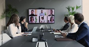 Diverse businesspeople take part in video conference call use application. Executives and group of multi-ethnic entrepreneurs, managers or investors engaged in virtual meeting. Modern tech, business