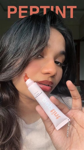 Ashrita Rachuri on Instagram: "Comment “link” 🔗 . A glossy lip that actually delivers. Tira’s plumping tinted peptides check all the boxes pigmented lip gloss, subtle non-sting plump, and a comfortable hydrating formula that works for everyday wear. The aesthetic packaging, plush applicator, and glossy finish make this an easy grab-and-go lip product. Perfect if you’re into peptide lip care, nourishing glosses, and that clean, glassy lip look without irritation. If you’re searching for a plumpi