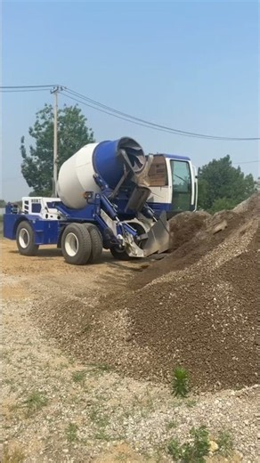 loading stones into a concrete mixer #construction #concrete