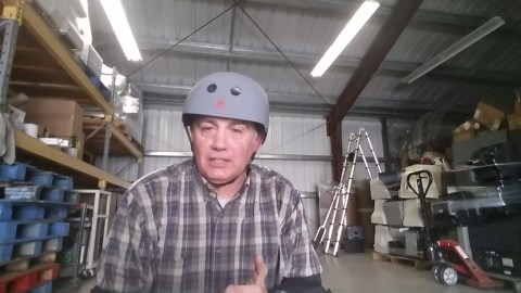 Guy Rides Tall Unicycle