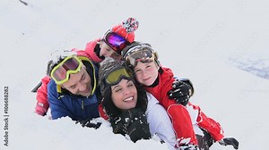 Portrait of family having fun laid in the snow