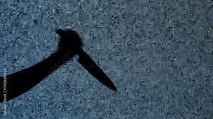 Silhouette against digital television screen. Thriller scene woman hand holding knife and stabbing it against digital screen with noise.