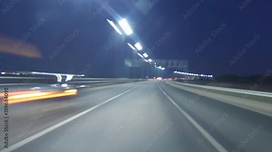 Time Lapse Driving Car On Highway At Dark POV. Hyper Lapse. Evening Sunset Street Lights. Night, Camera In Front, Windshield Reference. Hyperlapse in Evening City, Downtown. POV Futuristic Cityscape.