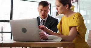 Colleagues are discussing working together on online project, using laptop. Teamwork cooperation, help and coaching concept