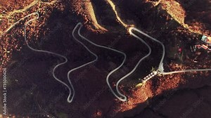 Serpentine road snakes through mountains harmony nature Serpentine road drive with imperative of safety. Serpentine path amidst towering peaks breathtaking views journey importance destination.