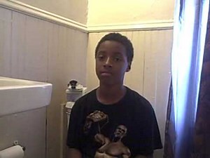 black kid sitting on toilet