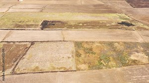 A harsh tableau: cracked terrain, painted in the hues of despair. Nature's lament echoes through the scorched earth, a testament to the toll of relentless exploitation.