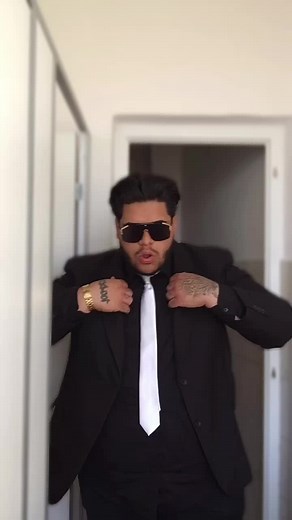 Stylish Man in Suit with Unique Tattoos