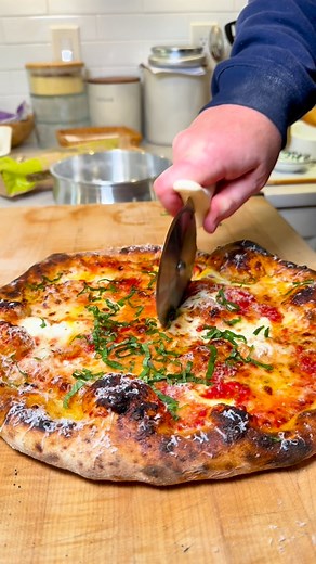 Sean Sullivan on Instagram: "Happy Pizza Friday, everyone! This is a simple, classic cheese pizza made with mozzarella and fresh mozzarella on a sourdough and poolish crust. I’ll link the dough recipe below."