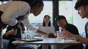 Coffee shop waitress use a table cloth that has been soiled with water. for cleanliness