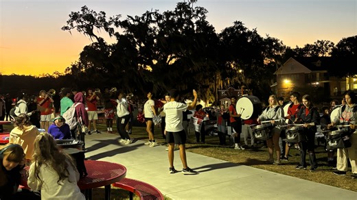 Leon High School Marching Redcoats perform at daybreak ahead of community band event
