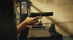 Person Reloading Pistol for Shooting at Range