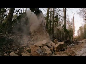 Hammering a big rock with the Agrotk 680 hydraulic hammer.