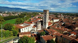 Italy ,Tuscany travel and landmarks. Lucca medieval historic town, 4k aerial drone video of city center with famous towers and squares
