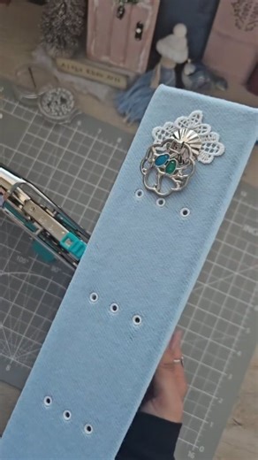 Aisha Khan on Instagram: "Preparing the cover to sew in the pages. I am using the Crop-A-Dile Big Bite tool to set the eyelets. #wintercottagejournal #junkjournal #scrapbooking"